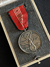 Cased 1936 Olympic medal. Presented to workers and contributors for the 1936 Olympics